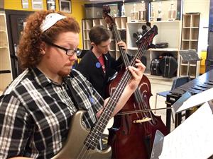 Two students playing instruments